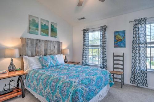 a bedroom with a bed and a desk and two windows at Charleston Townhome about 13 Mi to Sand and Surf! in Charleston