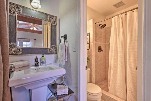 a bathroom with a sink and a toilet and a mirror at Tuscan Getaway with Premier Vineyard Views! in Cottonwood