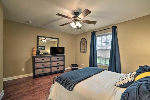 a bedroom with a bed with a ceiling fan and a dresser at Quaint Family Home Near Downtown Murray and MSU in Murray