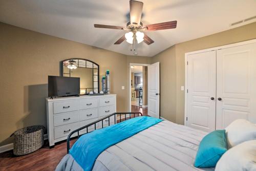 a bedroom with a bed and a ceiling fan at Quaint Family Home Near Downtown Murray and MSU in Murray