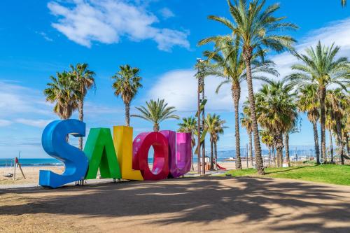 a sign at the beach with palm trees at Seaborn Salou in Salou