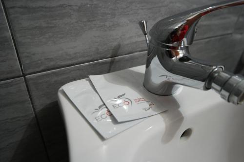 a hair dryer sitting on top of a toilet at Jonio B&B in Acireale