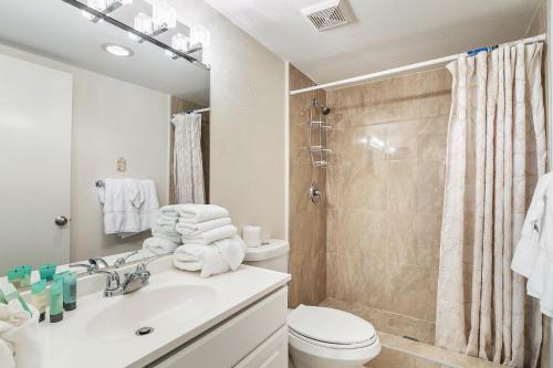a bathroom with a sink and a toilet and a shower at Ground Floor Cozy Condo Seconds from the Beach with Private Terrace in South Padre Island