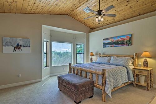 a bedroom with a bed with a wooden ceiling at Serene Lakeside Cabin with Decks and Edler Lake Views! in Pinetop-Lakeside