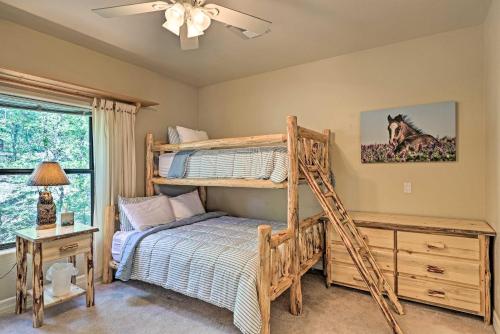 a bedroom with a bunk bed and a desk at Serene Lakeside Cabin with Decks and Edler Lake Views! in Pinetop-Lakeside
