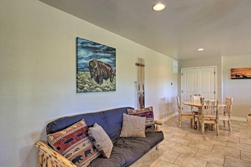 a living room with a couch and a table at Serene Lakeside Cabin with Decks and Edler Lake Views! in Pinetop-Lakeside