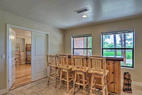 a dining room with a table and chairs at Serene Lakeside Cabin with Decks and Edler Lake Views! in Pinetop-Lakeside