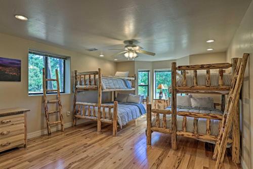 a bedroom with bunk beds and a ceiling fan at Serene Lakeside Cabin with Decks and Edler Lake Views! in Pinetop-Lakeside