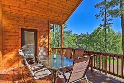 a dining table on the deck of a cabin at Serene Lakeside Cabin with Decks and Edler Lake Views! in Pinetop-Lakeside