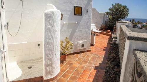 a bathroom with a shower and a tile floor at Casa CHARCO 5 in Charco del Palo