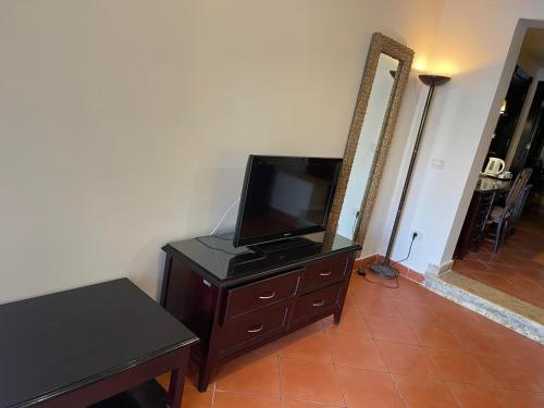 a television on a dresser in a living room at Patio suite, Porto marina in El Alamein