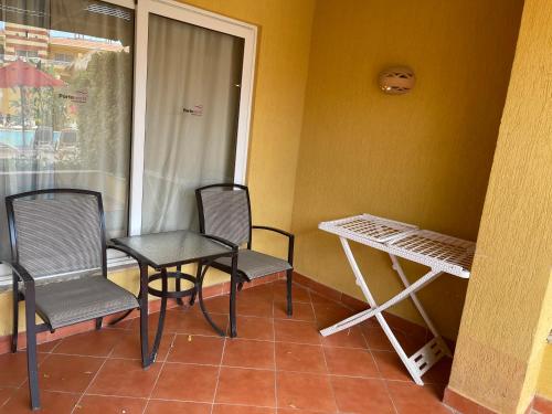 a room with chairs and a table and a window at Patio suit, Porto marina in El Alamein