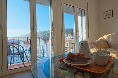 a glass table with a tray of food on a table at SeetheSea in Nazaré