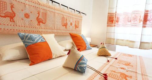 a bedroom with a bed with pillows on it at Affittacamere Le Ginestre in Cala Gonone