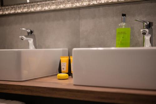 a bathroom counter with two sinks and a bottle of soap at Kleiner Alpiner Boudoir in der Residenz Silvretta - Inklusive Silvretta Card Premium in See