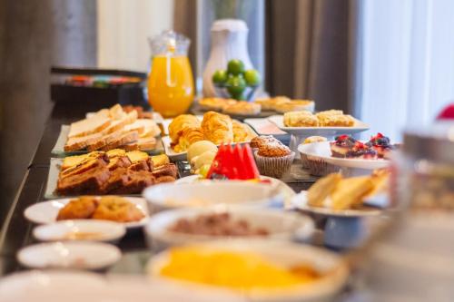 a buffet with many plates of food on a table at Prodeo Hotel + Lounge in Buenos Aires