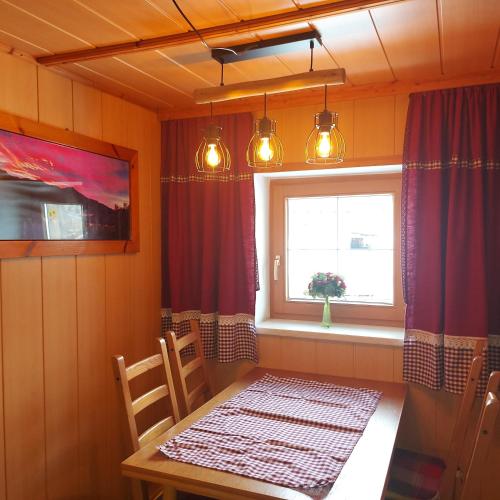a dining room with a table and a window at Badhaus in Achenkirch