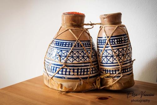 two vases sitting on top of a wooden table at Casa Il Melograno in San Miniato