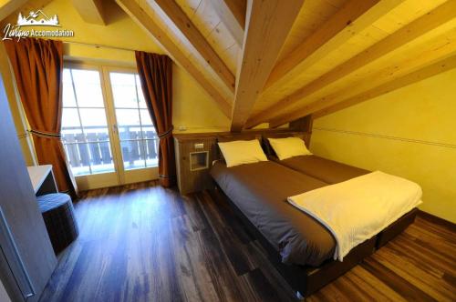 Postel nebo postele na pokoji v ubytování Alpen Flower by Livigno Accomodation