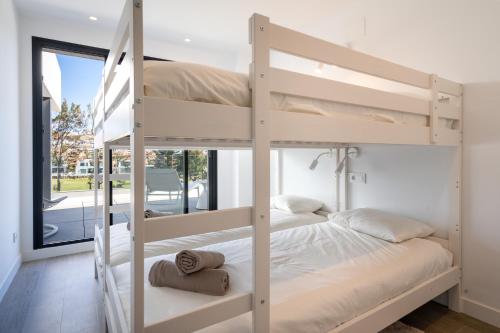 a bedroom with two bunk beds and a window at Holiday Apartment Navigolf La Cala in La Cala de Mijas