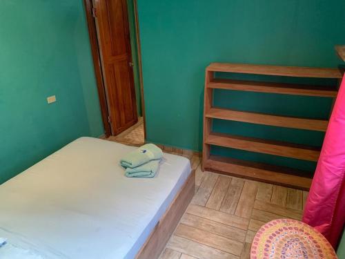 a small bedroom with a bed and a cabinet at Valerie Emanuel Apartments in Bocas Town