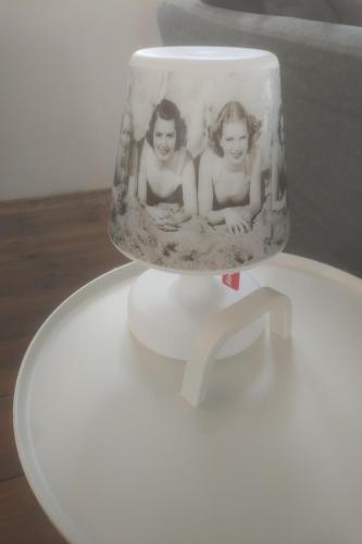 a vase with two girls on it sitting on a table at HouseBoat next to AMSTEL in Amsterdam