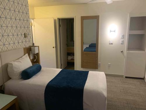 a bedroom with a bed with a blue pillow on it at Split Rock Resort in Lake Harmony