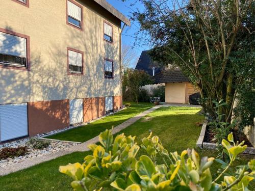 a house with a grass yard next to a building at Hotel Franken in Forchheim