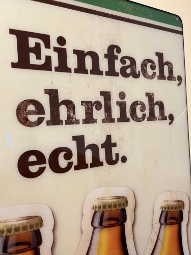 a sign that says drink cellar edit with two bottles of beer at HHotel Augsburg in Augsburg