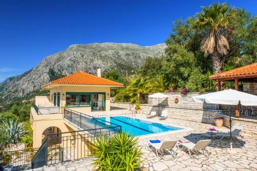 a villa with a swimming pool and a house at Villa Theaya in Nisakion