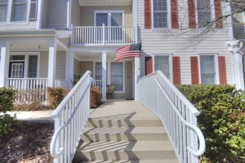 a white house with an american flag on it at 128E October Glory Ave, Ocean View in Ocean View