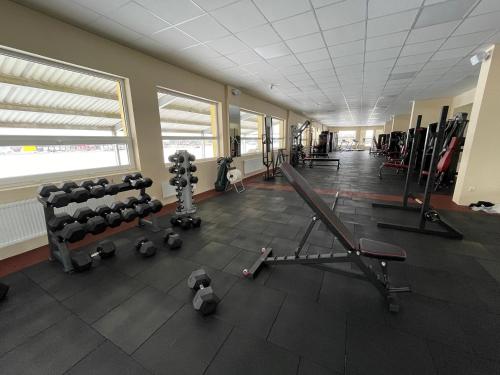 an empty gym with equipment in a large room at VILARHOTEL in Aizkraukle