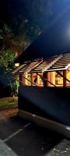 a building with a black roof and a building at Bungalow et Duplex de Island Bay in Bouillante