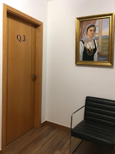 a door in a room with a painting of a woman at Sleep In Bucelas in Bucelas
