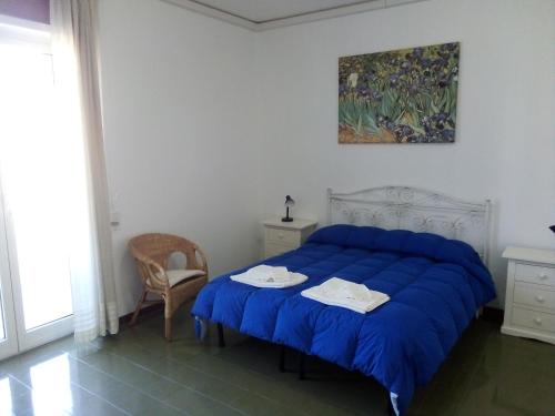 a bedroom with a blue bed and a table at Le Dimore di Otranto - Altomare in Otranto
