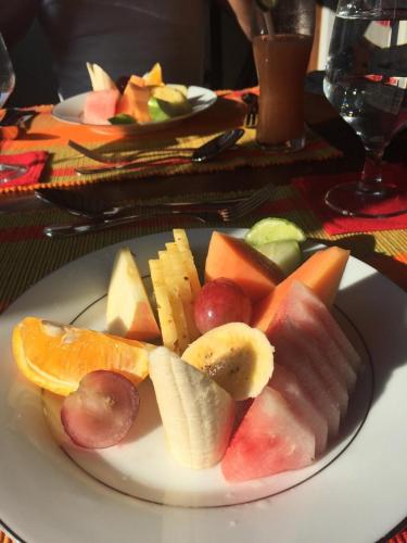 a plate of fruit and vegetables on a table at Gangula Villa in Kandy