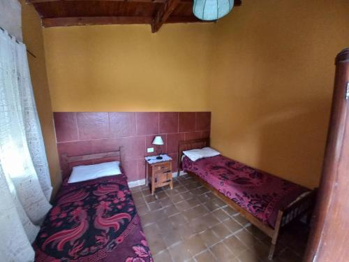 a small room with two beds and a table at La Casa de Pichona in Miramar