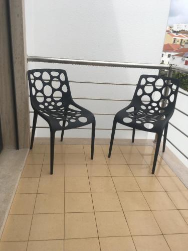 two chairs sitting on top of a balcony at Sleep In Bucelas in Bucelas