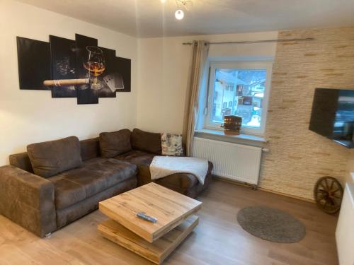 a living room with a couch and a coffee table at Ferienhaus Butterfly in Garmisch-Partenkirchen