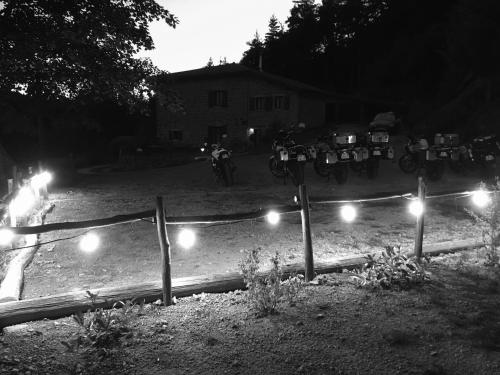 a group of motorcycles parked in a yard at night at Grange De Sagne maison et table d hôtes avec dîner sur réservation in Saint-Jean-Roure