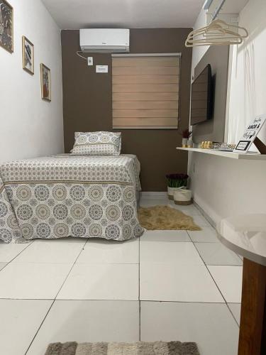 a bedroom with a bed and a sink at Flat JK 202 in Juazeiro do Norte
