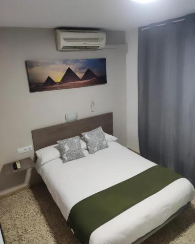 a bedroom with a large bed in a room at Pensión Zacatin in Granada