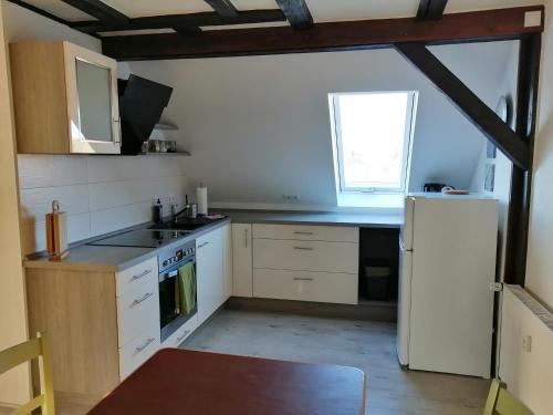 a kitchen with white appliances and a white refrigerator at alte Apotheke in Roßdorf