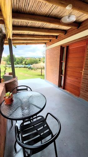 a patio with a table and chairs and a garage at Los Molles Suites -Solo 2 Pax- in Mina Clavero