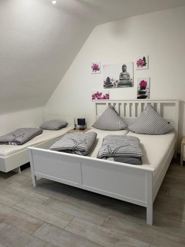 two white beds in a room with at Sweet Home Appartements in Bottrop