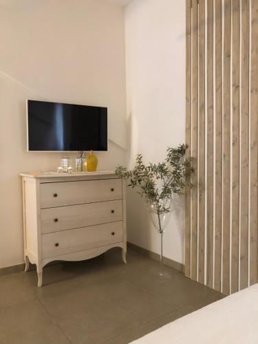 a tv on top of a dresser in a room at ZEROstuni suite apartment in Ostuni