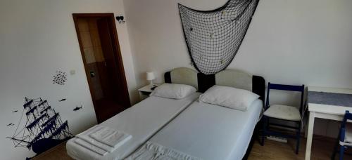 a bedroom with a bed with a net hanging above it at Apartmani Neva Supetar in Supetar