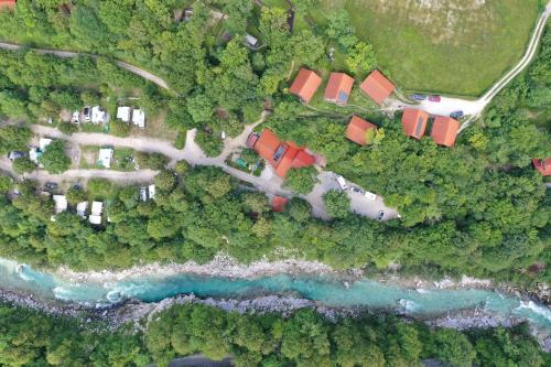 an aerial view of a house next to a body of water at Kamp Koren Kobarid in Kobarid