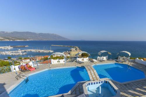 a swimming pool with a view of the ocean at Pavlis Studios Ormos in Marathokampos