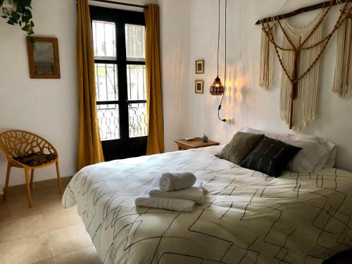 a bedroom with a large bed with towels on it at Casa Guidai in Granada